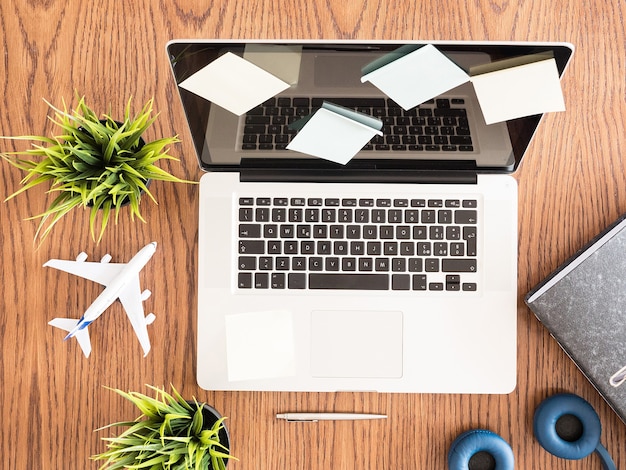 Top view of business man laptop, pot of  grass , wood desk