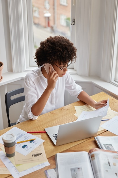 Top view of busy female startuper works from home