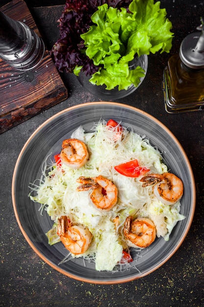 Top view caesar salad with fried shrimp