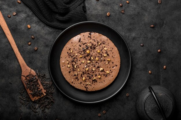 Top view of cake on plate with spatula and coffee beans