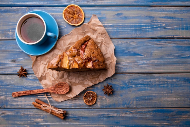 Top view of cake slice with cup of tea