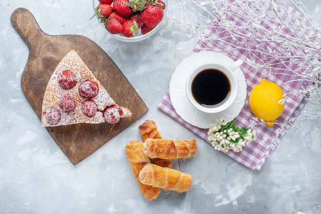 Top view of cake slice with fresh red strawberries sweet bangles and coffee on light desk, sweet bake biscuit cookie tea pastry