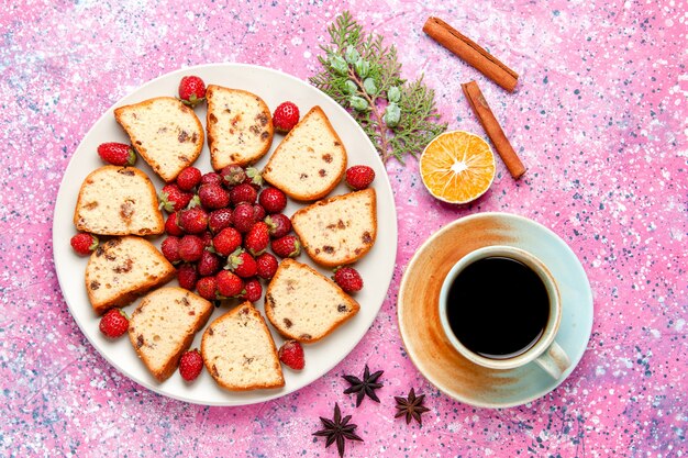 Top view cake slices with raisins inside plate with fresh strawberries on light-pink desk cake bake sweet biscuit color pie sugar cookie