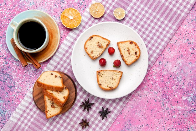 Top view cake slices with strawberries inside plate with coffee on the pink surface cake bake sweet biscuit sugar color photo