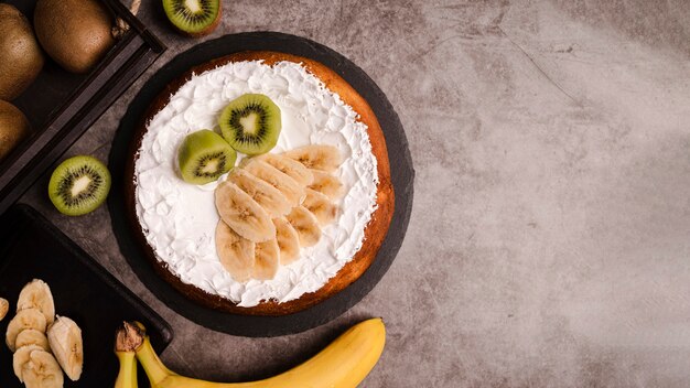 Top view of cake with banana slices and copy space