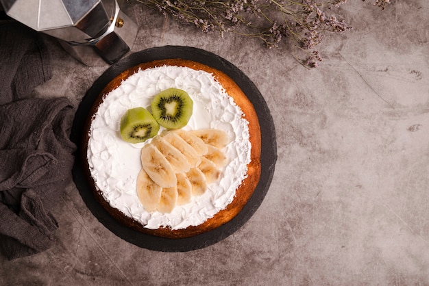 Top view of cake with kiwi and banana slices