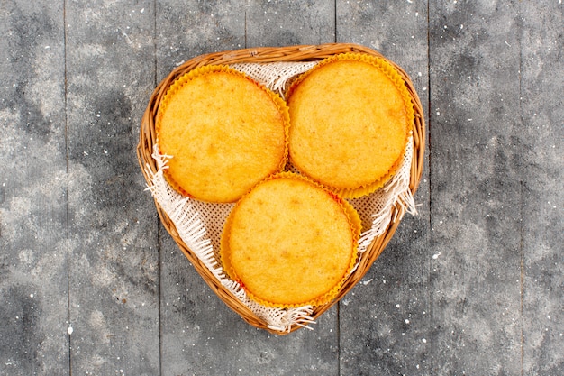 top view cakes cooked yummy inside basket on the grey rustic wooden