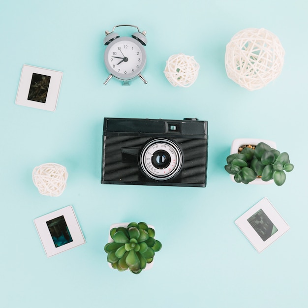 Top view camera with negatives, clock and plants