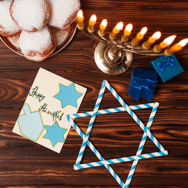 Top view candleholder with doughnuts on a table