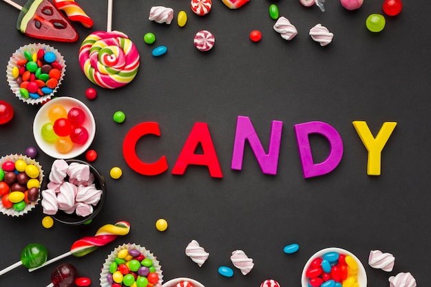 Top view candy lettering with sweets around