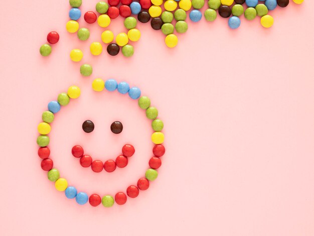 Top view candy on pink background