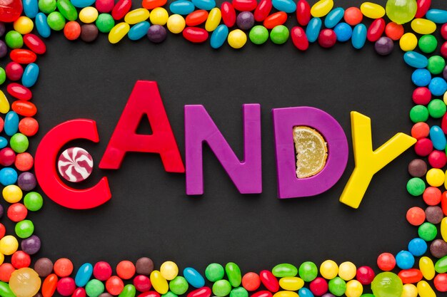 Top view candy word and sweets frame