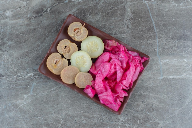 Top view of canned vegetables on brown plate over grey background. 