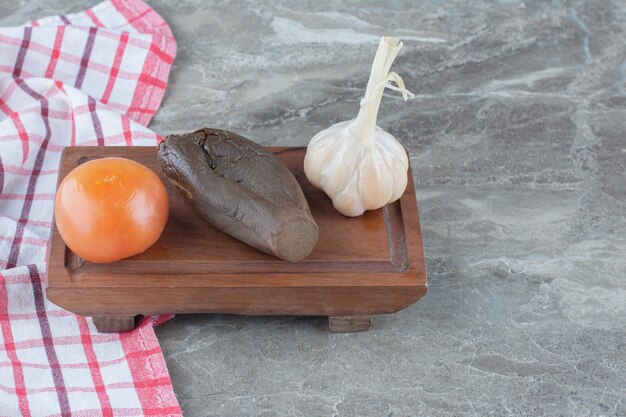 Top view of canned Vegetables. Tomato, eggplant and garlic on wooden board.