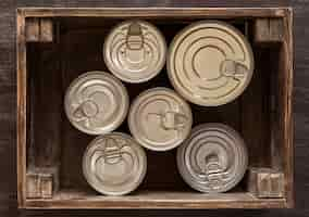 Free photo top view cans in wooden crate