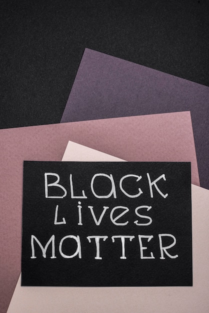 Top view of card with black lives matter on multicolored paper