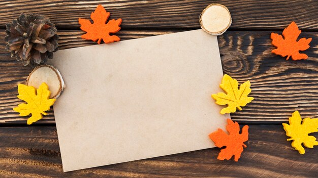 Top view card with leaves on wooden background