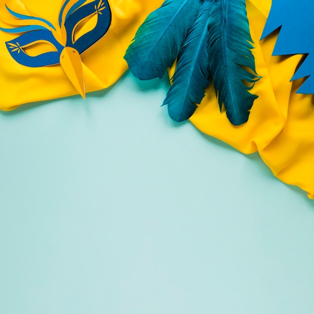 Top view of carnival mask and feathers
