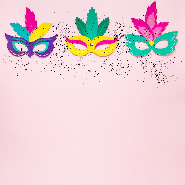 Top view of carnival masks with glitter