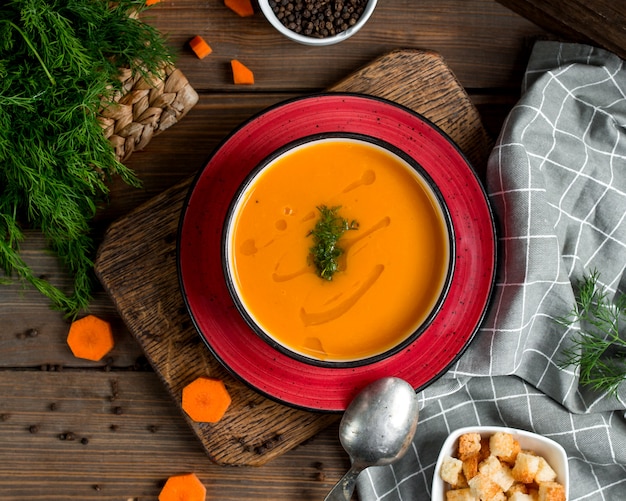 Free photo top view of carrot soup bowl garnished with dill