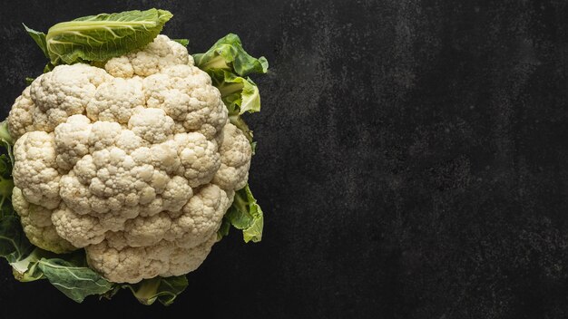 Top view cauliflower with leaves copy space