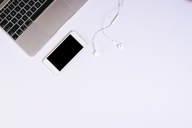 Top view cell phone on white desk