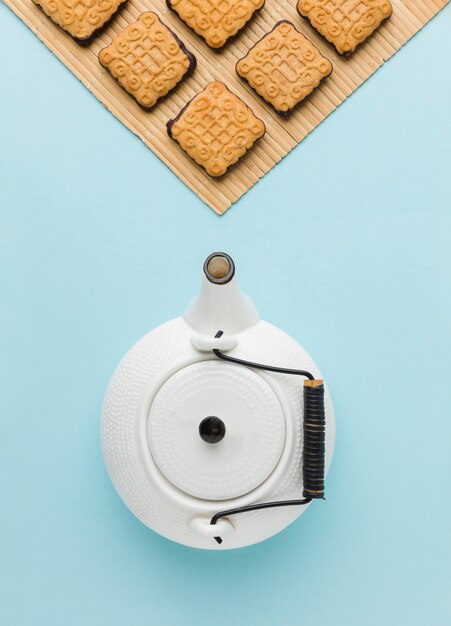 Top view ceramic teapot with homemade biscuits