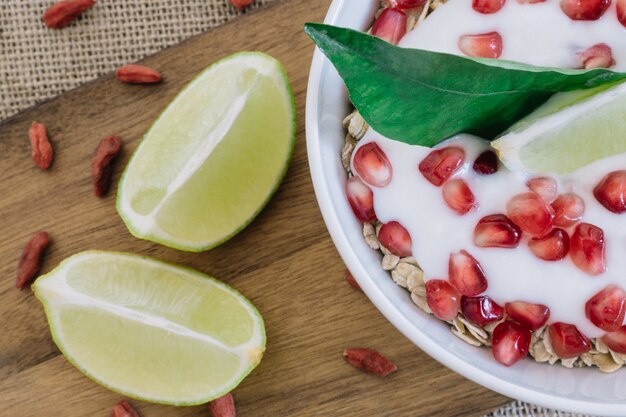 Top view of cereals with yogurt and pomegranate