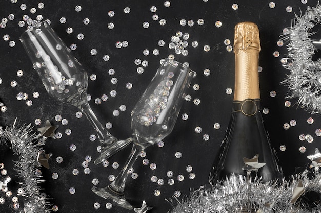 Free photo top view champagne bottle and glasses