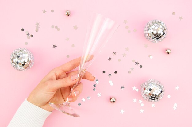 Top view champagne glass surrounded by globes