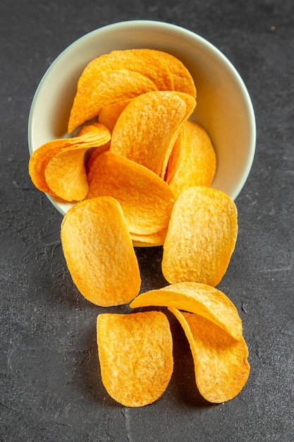 Top view cheese cips inside plate on dark background