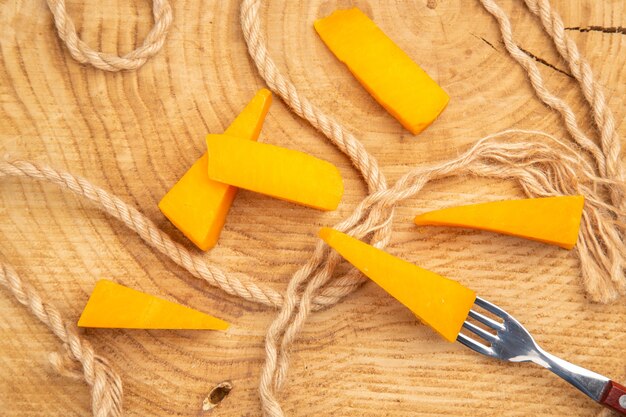Top view cheese on fork slices of cheese and rope