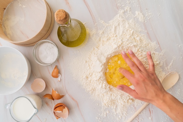 Top view chef mixing egg in flour