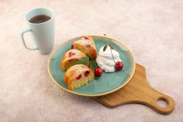 A top view cherry cake inside plate on the wooden desk with cherries on the pink desk cake biscuit sugar sweet