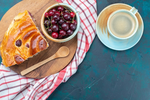 top view of cherry pie piece with fresh sour cherries on dark-blue desk,  cake pie fruit sweet sugar