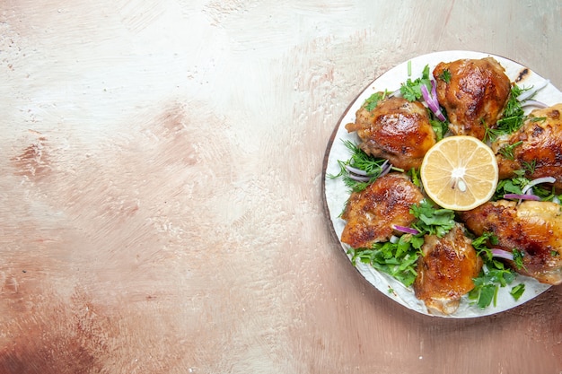 Top view of chicken the appetizing pieces of chicken lemon herbs on lavash on the board