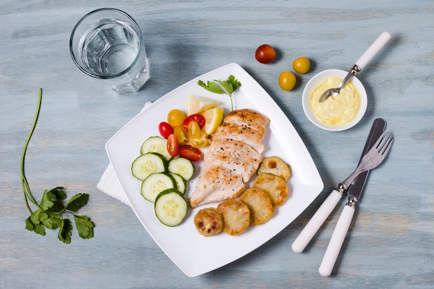 Top view of chicken breast with assortment of vegetables