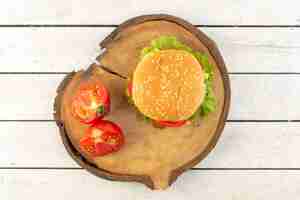 Free photo a top view chicken burger with cheese and green salad