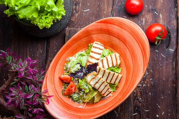 Top view chicken caesar salad grilled chicken breasts and fresh salad in plate