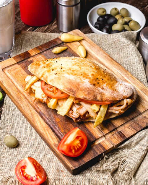 Top view of chicken doner with tomato french fries and pickles