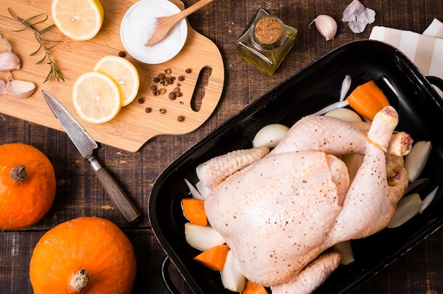 Top view of chicken in pan with lemon slices for thanksgiving