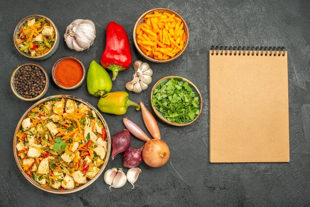 Top view chicken salad with vegetables on dark table diet health meal