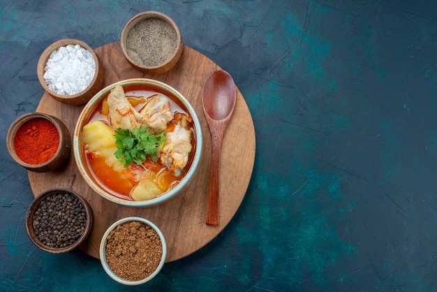 Top view chicken soup along with seasonings on the dark-blue desk soup meat food dinner meal