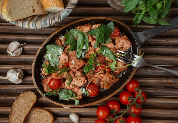 Top view chicken stew in a pan with herbs 