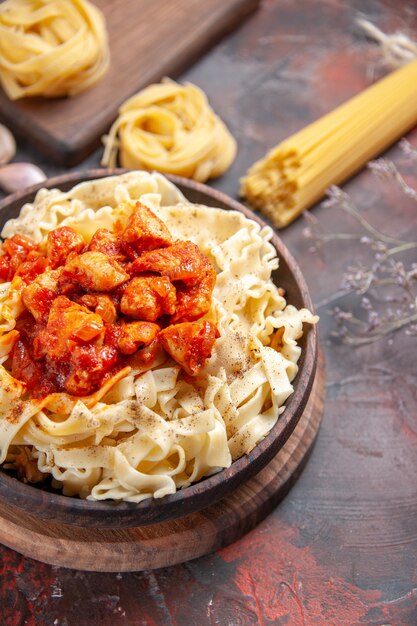 Top view chicken with dough pasta dish on a dark surface pasta dough meal dark