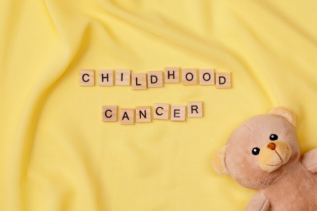 Free photo top view over childhood cancer awareness month background concepttoys,