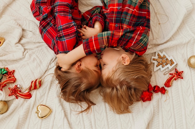 Free photo top view children being close in bed on christmas