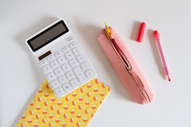 Top view of children's desk with calculator and pen