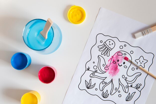 Top view of children's desk with paint and drawing