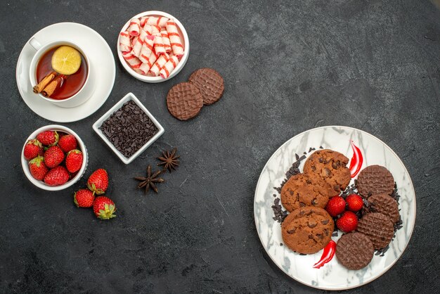 Top view choco biscuits with candies and fruits